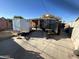 Backyard with two trailers and a storage shed at 11217 W Missouri Ave, Youngtown, AZ 85363