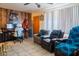 Living room with wood paneled wall and comfy seating at 11217 W Missouri Ave, Youngtown, AZ 85363