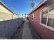 Side yard with a walkway between block walls at 11217 W Missouri Ave, Youngtown, AZ 85363