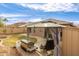 Landscaped backyard featuring a grill area with stainless grill under a gazebo with backyard furniture at 11810 W Belmont Dr, Avondale, AZ 85323