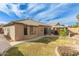 Well-maintained backyard featuring a covered gazebo, desert landscaping, and a beige stucco home with tile roof at 11810 W Belmont Dr, Avondale, AZ 85323