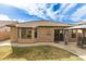 Backyard view of a beige stucco home with a tile roof, and a covered gazebo with patio furniture at 11810 W Belmont Dr, Avondale, AZ 85323