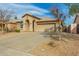 Well-maintained single-story home with desert landscaping and a two-car garage at 11810 W Belmont Dr, Avondale, AZ 85323