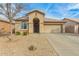 Charming single-story home featuring a desert landscaped front yard and covered entryway at 11810 W Belmont Dr, Avondale, AZ 85323