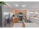 Well-lit kitchen featuring stainless steel appliances and a breakfast bar area with natural light at 11810 W Belmont Dr, Avondale, AZ 85323