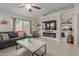 Bright living room featuring tile floors, neutral paint, and backyard view at 11810 W Belmont Dr, Avondale, AZ 85323