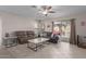 Inviting living room with tile floors, ceiling fan, and sliding glass doors at 11810 W Belmont Dr, Avondale, AZ 85323