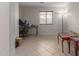 Spacious home office featuring neutral walls, tile floors, and natural light through window with blinds at 11810 W Belmont Dr, Avondale, AZ 85323