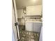 Laundry room with washer, dryer, and built-in shelving at 12226 N Lakeforest Dr, Sun City, AZ 85351