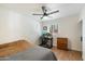 Bedroom with a workspace, ceiling fan, and wood floors at 1510 E Mission Ln, Phoenix, AZ 85020