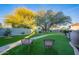 Landscaped backyard with artificial turf, stone pathway, and two chairs at 15302 E Lotus Ln, Fountain Hills, AZ 85268