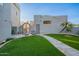 Artificial turf, stone pathway, and seating area near the house at 15302 E Lotus Ln, Fountain Hills, AZ 85268