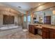 Bathroom with double vanity, large mirror, and elegant stonework at 15302 E Lotus Ln, Fountain Hills, AZ 85268