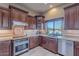 Modern kitchen with stainless steel appliances and granite countertops at 15302 E Lotus Ln, Fountain Hills, AZ 85268