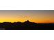 Stunning sunset over silhouette mountains at 15302 E Lotus Ln, Fountain Hills, AZ 85268