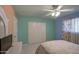 Bedroom with ceiling fan, double closet, and tiled floors at 1555 W 7Th Pl, Mesa, AZ 85201