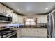 Bright kitchen features ample cabinetry, granite countertops, and stainless steel appliances at 1555 W 7Th Pl, Mesa, AZ 85201