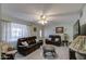 Spacious living room with leather furniture and a large TV at 1555 W 7Th Pl, Mesa, AZ 85201