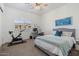 Comfortable bedroom with a queen-size bed, exercise bike, and window seat at 15550 S 5Th Ave # 240, Phoenix, AZ 85045