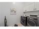 Convenient laundry room with washer, dryer, and overhead cabinets at 15550 S 5Th Ave # 240, Phoenix, AZ 85045