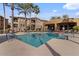 Community pool with lounge chairs and a covered patio area at 15550 S 5Th Ave # 240, Phoenix, AZ 85045