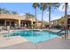 Community pool with surrounding lounge chairs and landscaping at 15550 S 5Th Ave # 240, Phoenix, AZ 85045