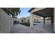 Spacious backyard with stone-tiled patio, pool, and verdant landscaping at 16846 W Hilton Ave, Goodyear, AZ 85338