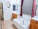 Main bathroom with bathtub, double sinks, and window at 16846 W Hilton Ave, Goodyear, AZ 85338