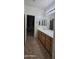 Bathroom vanity with double sinks, wooden cabinets, and a large mirror with elegant lighting fixtures above at 16846 W Hilton Ave, Goodyear, AZ 85338