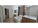 A bright bathroom showcases a soaking tub and a double sink vanity, complemented by tile flooring and a separate shower stall at 16846 W Hilton Ave, Goodyear, AZ 85338