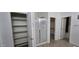 Bathroom area featuring linen closet, glass shower and doorway to another room at 16846 W Hilton Ave, Goodyear, AZ 85338