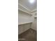 Walk-in closet with shelves and carpet at 16846 W Hilton Ave, Goodyear, AZ 85338