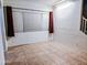 Empty dining room with tile floors and large window at 16846 W Hilton Ave, Goodyear, AZ 85338