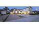 Two-story home featuring a driveway, neutral color scheme, a palm tree, and a well-manicured front yard at 16846 W Hilton Ave, Goodyear, AZ 85338