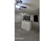 Living room showing staircase with a view of the bedroom windows at 16846 W Hilton Ave, Goodyear, AZ 85338