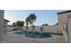 Backyard featuring a swimming pool with waterfall features and surrounding landscaping at 16846 W Hilton Ave, Goodyear, AZ 85338