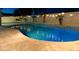 Luxury pool with water features and string lights illuminating the night at 16846 W Hilton Ave, Goodyear, AZ 85338