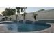 Beautiful pool area with waterfalls and lush tropical landscaping at 16846 W Hilton Ave, Goodyear, AZ 85338