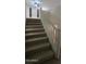 Carpeted staircase with a white railing leading to the second floor at 16846 W Hilton Ave, Goodyear, AZ 85338