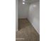 A simple storage space features neutral tile flooring, white walls, and a ceiling vent, offering practical utility at 16846 W Hilton Ave, Goodyear, AZ 85338