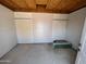 Spacious garage features concrete flooring, wall panels and OSB wood ceilings ready for custom design and storage solutions at 1714 N Pleasant Dr, Chandler, AZ 85225