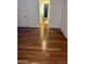 Hallway featuring hardwood floors, a white interior door and view into bathroom at 1714 N Pleasant Dr, Chandler, AZ 85225