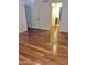 Hallway featuring hardwood floors, a white interior door and view into bathroom at 1714 N Pleasant Dr, Chandler, AZ 85225