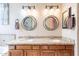 Bathroom with double vanity, granite countertops, and decorative mirrors at 17581 W Canyon Ln, Goodyear, AZ 85338