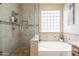 Bathroom includes a large shower, soaking tub, and tiled walls at 17581 W Canyon Ln, Goodyear, AZ 85338