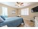 Spacious bedroom with a ceiling fan, large window, and a dresser at 17581 W Canyon Ln, Goodyear, AZ 85338