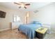 Bedroom with queen bed, ceiling fan, dresser and ensuite bathroom access at 17581 W Canyon Ln, Goodyear, AZ 85338