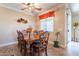 Dining room with wooden table and chairs, ceiling fan, and access to patio at 17581 W Canyon Ln, Goodyear, AZ 85338