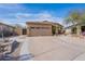 Front view of a house with a two-car garage and nicely landscaped yard at 17581 W Canyon Ln, Goodyear, AZ 85338