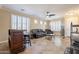 Living area with leather sofas, a coffee table, and a home bar at 17581 W Canyon Ln, Goodyear, AZ 85338